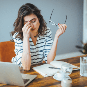 Mulher moderna demonstrando sinais de estresse no trabalho, ilustrando os impactos do estresse na saúde da mulher moderna